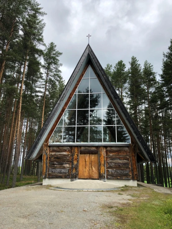 a small church sitting in the middle of a forest, an album cover, inspired by Eero Järnefelt, unsplash, modernism, 🚿🗝📝, peaked wooden roofs, ceremony, very clear view