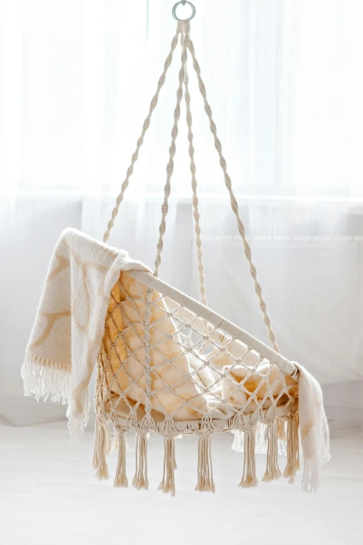 a hammock hanging in front of a window, in a white boho style studio, throne, precious moments, premium