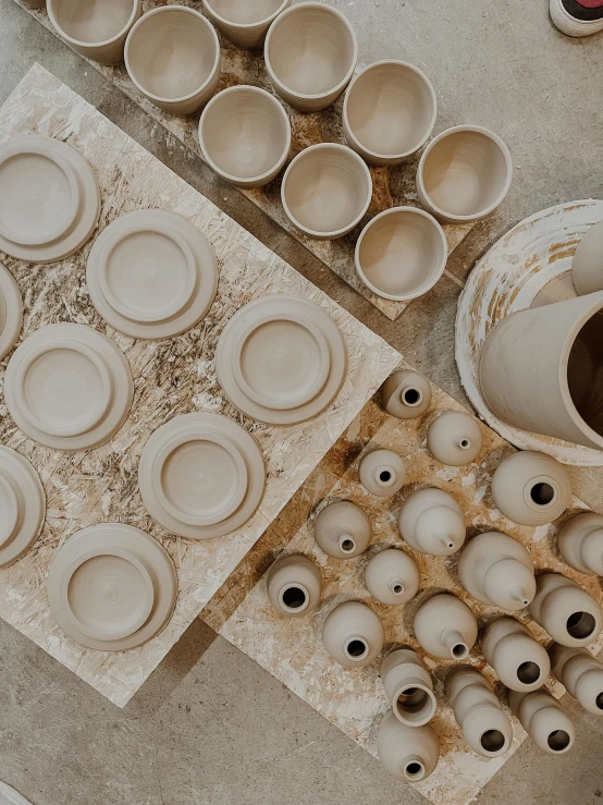 a table that has some cups and bowls on it, inspired by Ai Weiwei, trending on unsplash, process art, beige cream natural muted tones, holes, thumbnail, pov photo