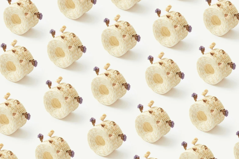 a bunch of straw baskets sitting on top of a white surface, inspired by Cerith Wyn Evans, trending on pexels, violet beetles, seamless micro detail, in the shape of a cinnamon roll, pale yellow wallpaper