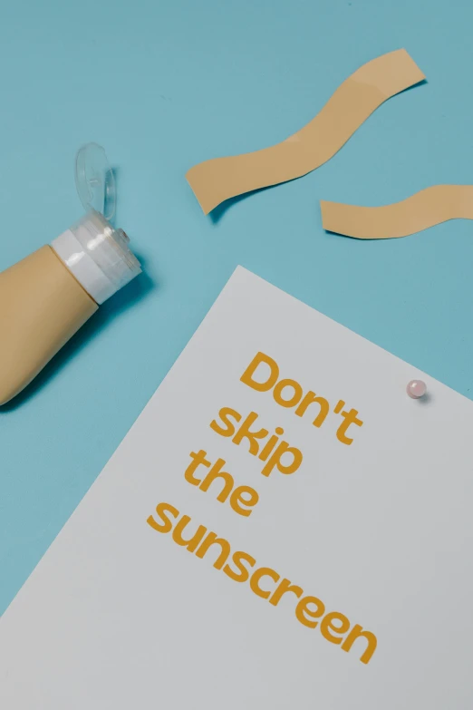 a bottle of sunscreen next to a piece of paper that says don't skip the sunscreen, unsplash, conceptual art, nasal strip, light tan, poster ; summer, silicone skin