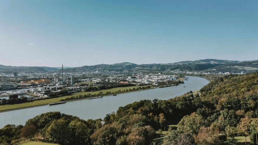 a river running through a lush green hillside, by Tobias Stimmer, pexels contest winner, happening, view over city, high quality product image”, brown, 90s photo