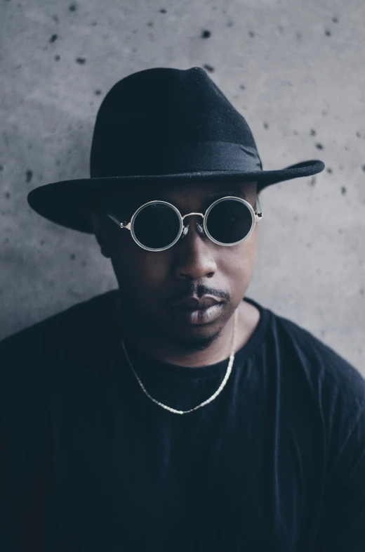 a man wearing a black hat and sunglasses, inspired by Zhu Da, unsplash, afrofuturism, looking confused, kendrick lamar, pout, dolman