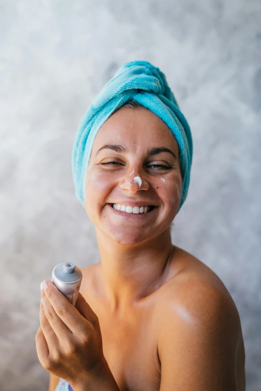 a woman with a blue towel on top of her head, bubbling skin, smiling woman, with grey skin, tanned skin