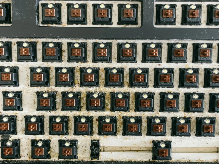 a close up of an old computer keyboard, by Jan Kupecký, top down extraterrestial view, rusted panels, brown, knobs