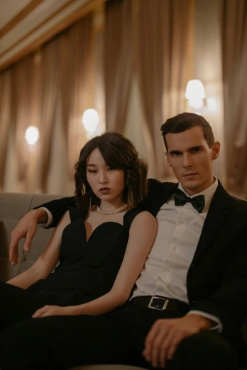 a man and a woman sitting on a couch, a portrait, by Emma Andijewska, trending on pexels, art nouveau, black tie, janice sung, formal wear, waist up