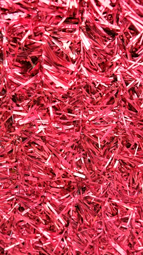 a close up of a pile of red tinsel, cut paper texture, ((pink)), instagram picture, sharp high quality photo