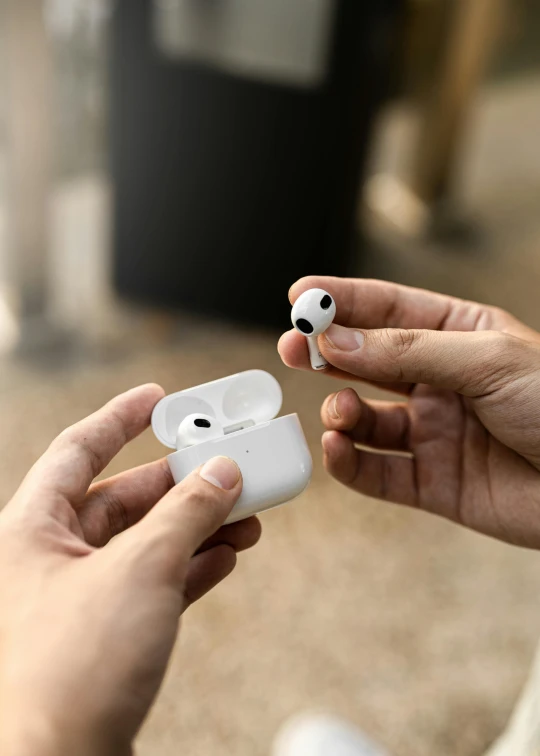 a person holding a pair of airpods in their hands, slide show, square, thumbnail