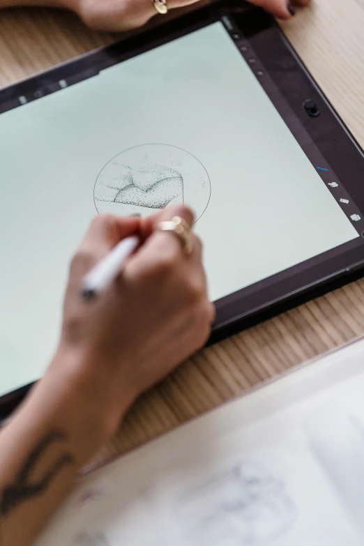 a person sitting at a table drawing on a tablet, a drawing, promo image, 9 9 designs, graphic detail, centered shot