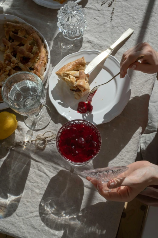 a couple of people that are sitting at a table, a still life, by Nina Hamnett, pexels contest winner, recipe, sweden, crimson fork, syrup