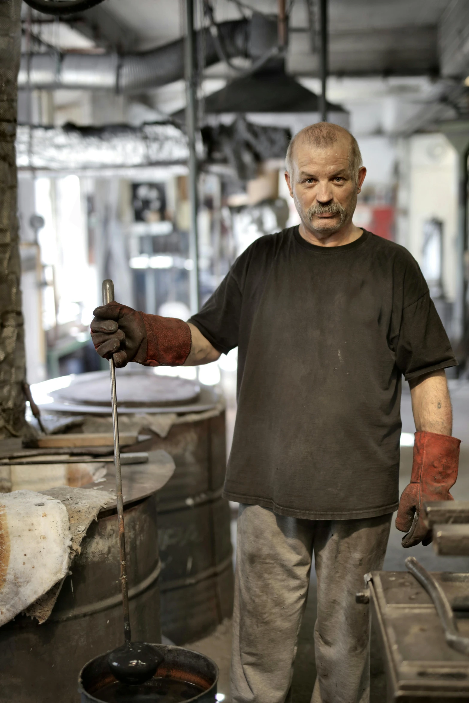 a man that is standing in a room, a portrait, arbeitsrat für kunst, working in the forge, promo image, white metal, australian