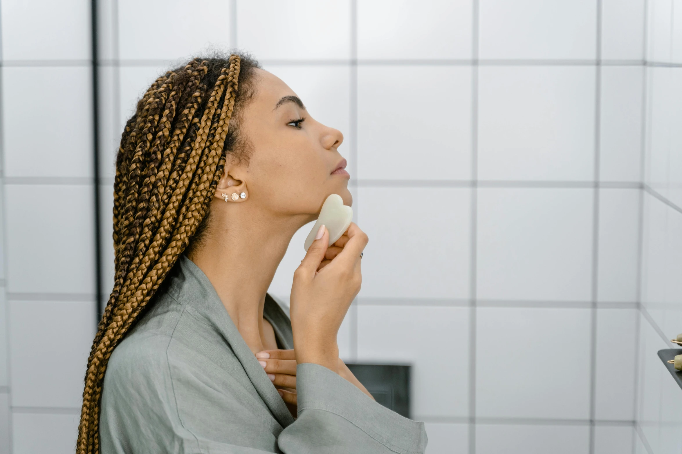 a woman brushing her teeth in front of a mirror, trending on pexels, renaissance, scales covering her chest, with brown skin, realistic », carved soap