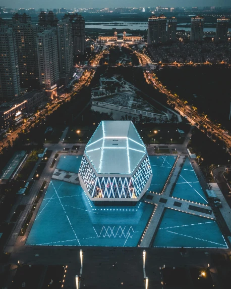 an aerial view of a city at night, a hologram, by Zha Shibiao, unsplash contest winner, a pool inside the giant palace, shenzhen, geodesic architecture, square