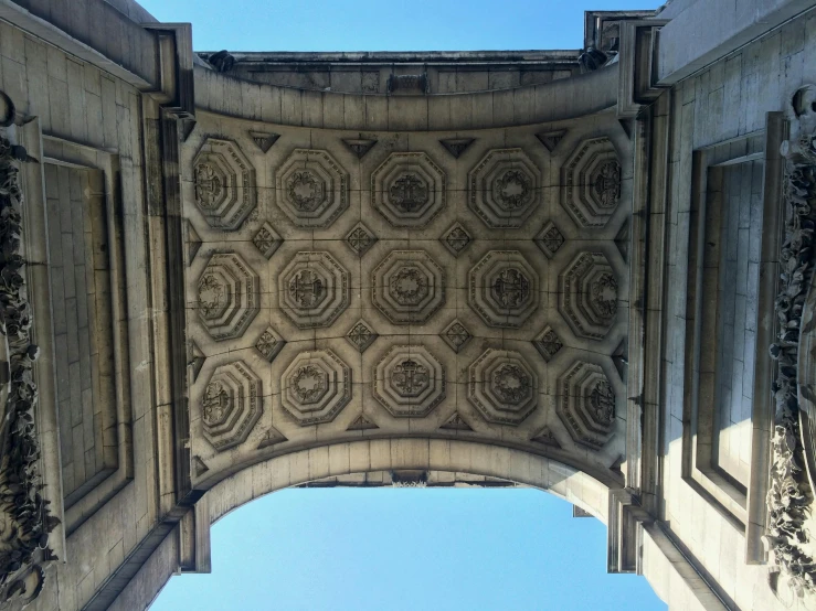 a close up of a building with a sky background, by Jessie Algie, unsplash, berlin secession, lots of roman arches, overhead canopy, looking through a portal, highly detailed stonework