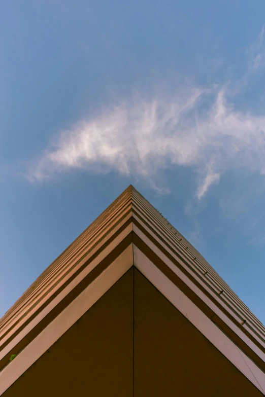 the top of a building with a sky background, by Carey Morris, unsplash, postminimalism, triangular face, brown, square lines, high-angle