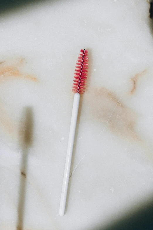 a close up of a toothbrush on a counter, by Nicolette Macnamara, detailed lashes, gradient white to red, with a straw, 8