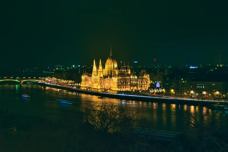 a large building next to a river at night, pexels contest winner, baroque, austro - hungarian, panoramic view, plain background, parliament