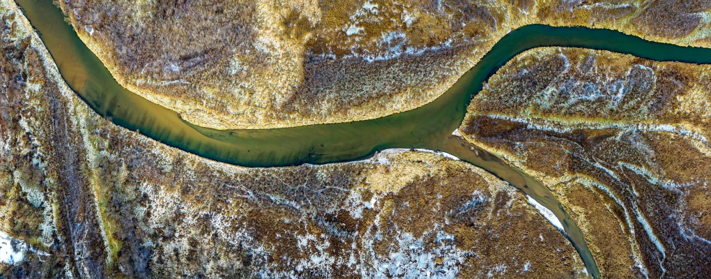 a river running through a lush green valley, by Sebastian Spreng, unsplash contest winner, conceptual art, winter, sand banks, rhode island, thumbnail