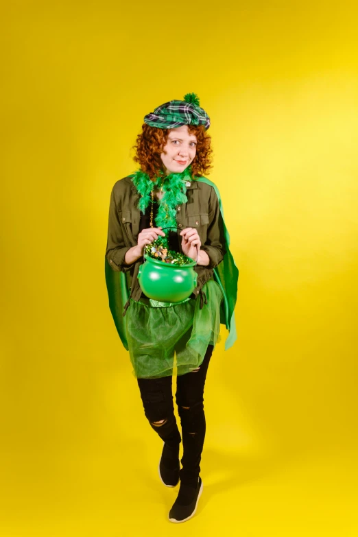 a woman in a green costume holding a green pot, by Pamela Drew, shutterstock contest winner, bubbling cauldron!, irish youtuber, costume desig, pose 4 of 1 6