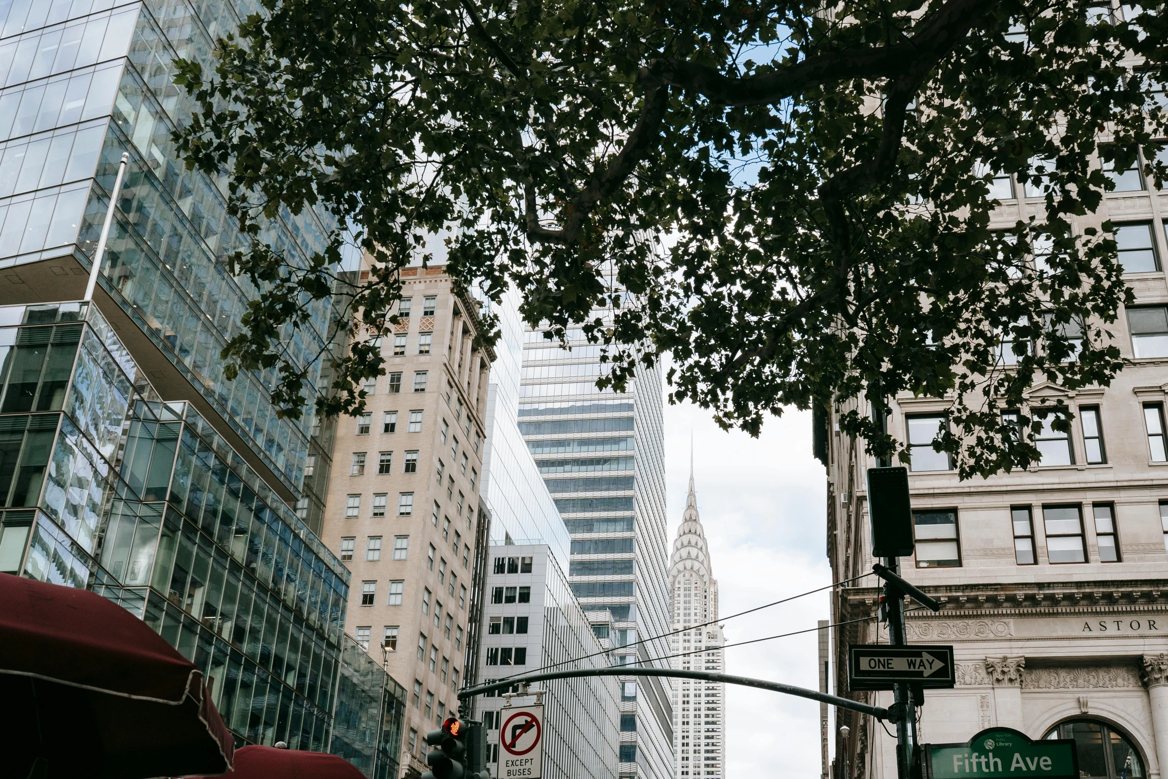 a city street filled with lots of tall buildings, a photo, chrysler building, background image, trees around, lomography photo