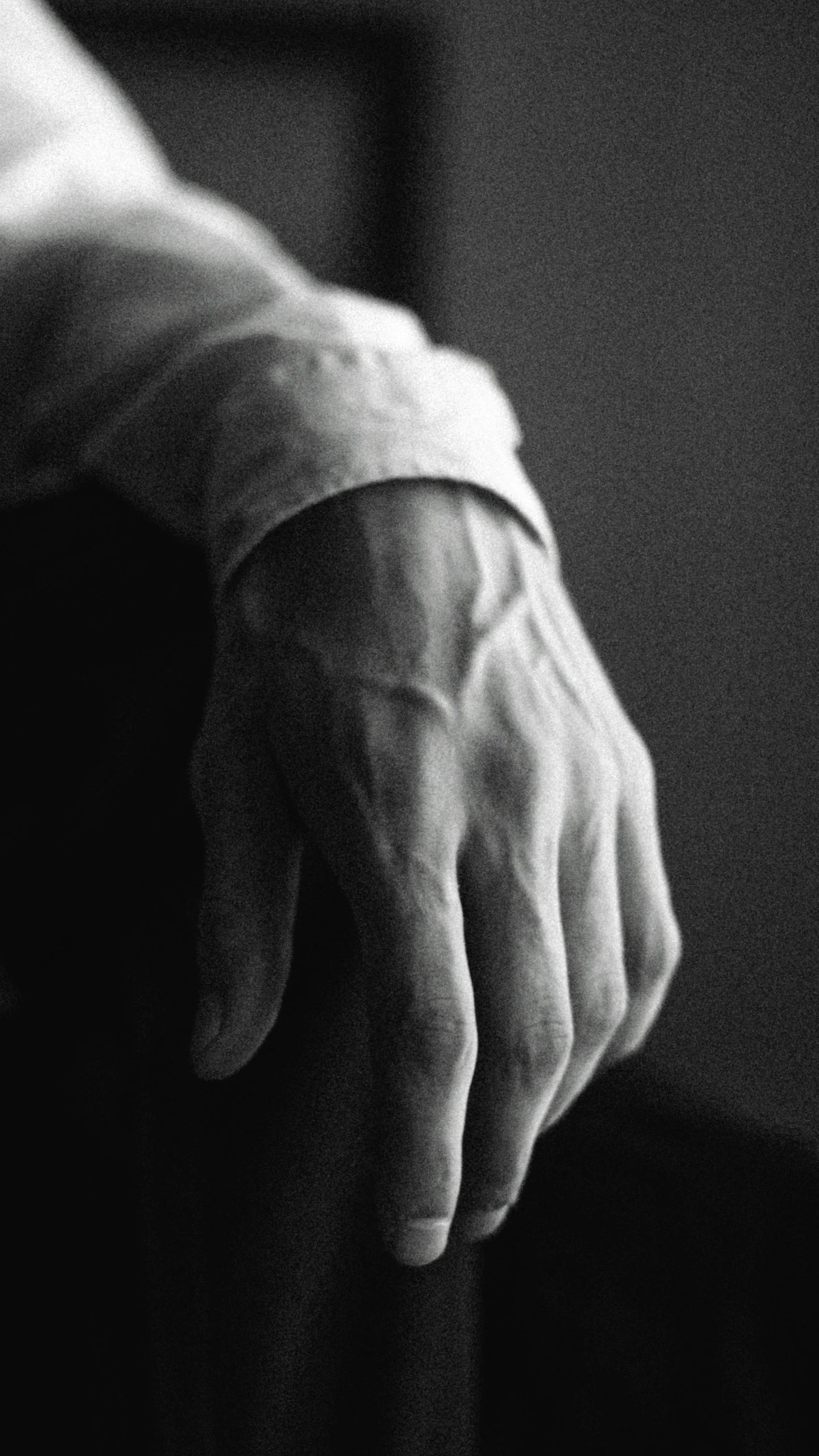 a close up of a person's hand on a chair, inspired by Germaine Krull, unsplash, romanticism, a handsome, white sleeves, high details photo