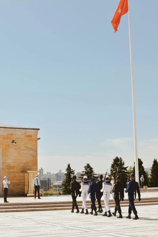 a group of people standing in front of a building, 1 0 0 meter in the distance, clear skies in the distance, ceremonial, helipad