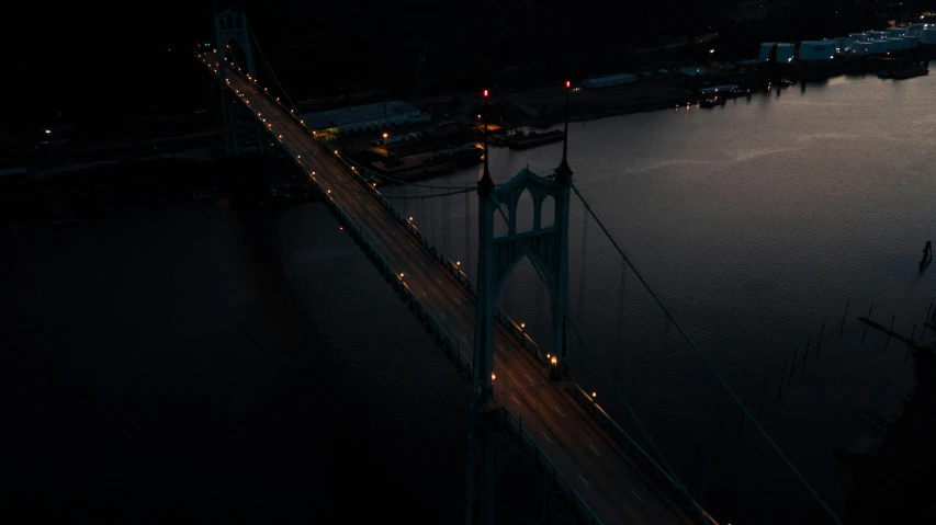 a bridge over a body of water at night, by Dan Christensen, pexels contest winner, view from helicopter, pittsburg, album cover, dishonored aesthetic