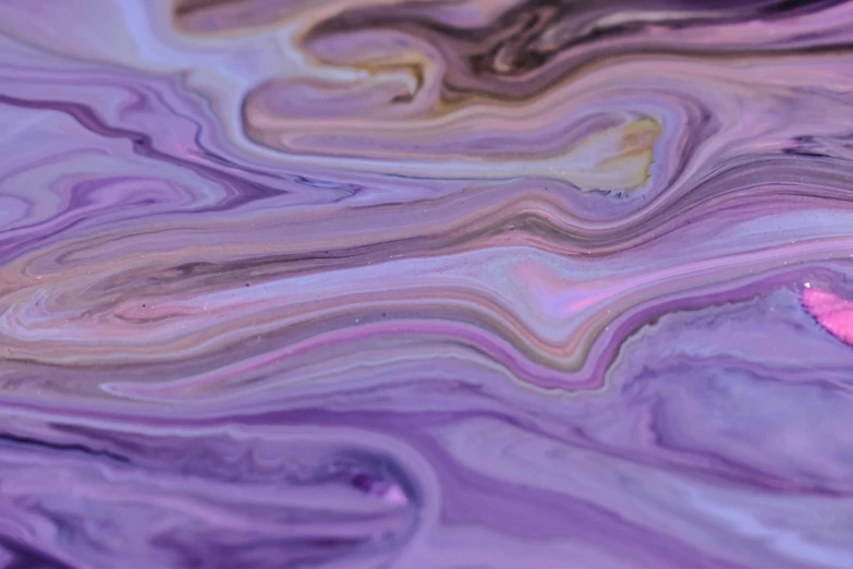 a close up of a piece of art on a table, inspired by Julian Schnabel, trending on pexels, abstract art, purple liquid, oganic rippling spirals, background pastel, abstraction chemicals
