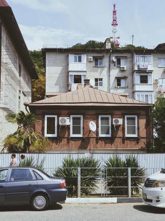 a couple of cars that are parked in front of a building, a photo, pexels contest winner, danube school, house on a hill, sovietwave aesthetic, 😭 🤮 💕 🎀, square