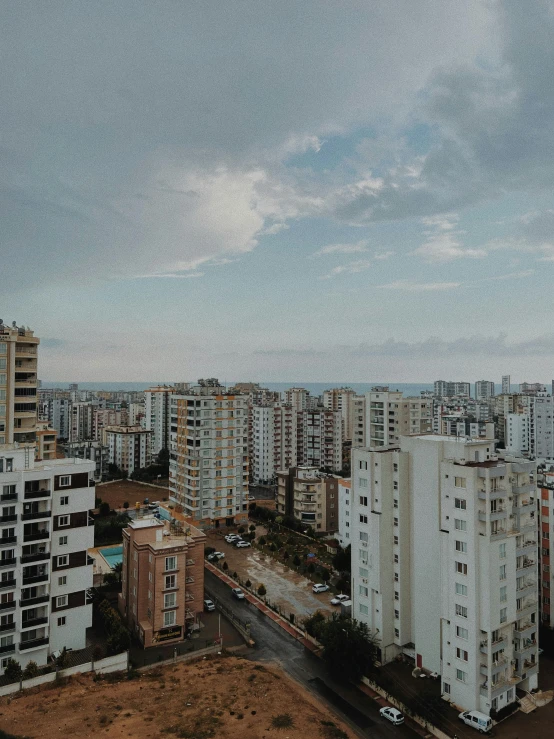 a view of a city from the top of a building, by Ismail Acar, low quality photo, 4 k cinematic photo, apartment, pearly sky