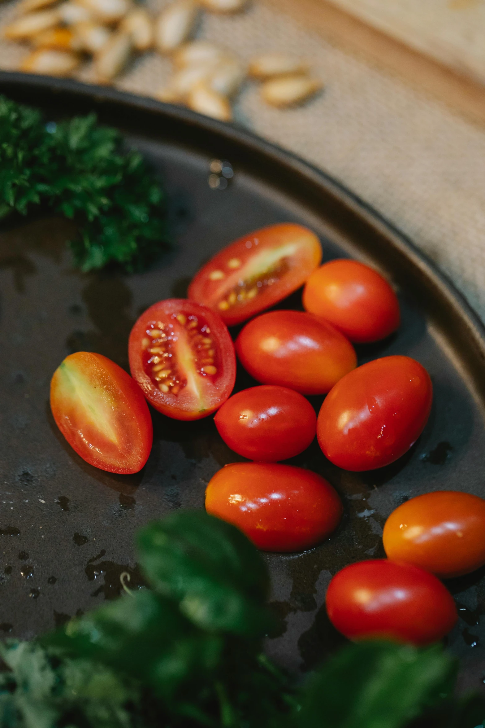 a black plate topped with tomatoes and broccoli, a still life, unsplash, forest gump tomato body, abundant fruition seeds, soft shade, petite