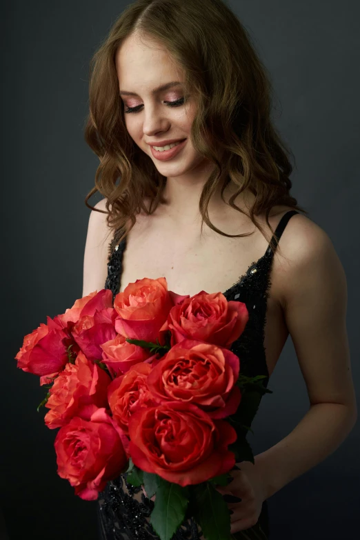 a woman holding a bouquet of red roses, by Winona Nelson, studio photoshoot, gorgeous female alison brie, she is wearing a black tank top, ethereal beauty