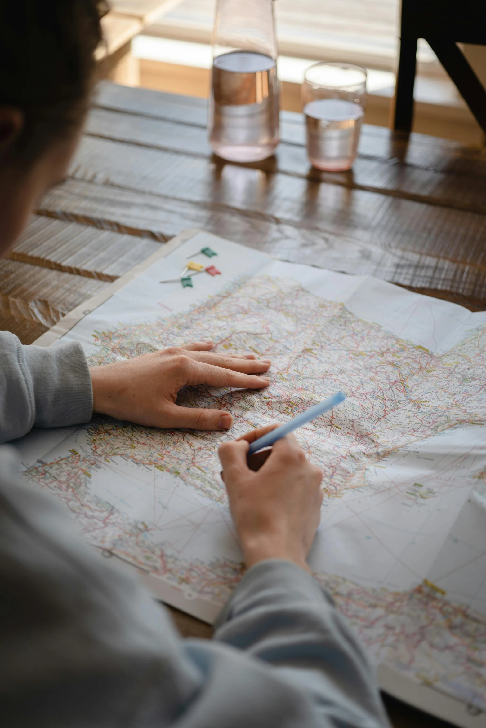 a person sitting at a table looking at a map, sharpie, 2019 trending photo, kids, journey