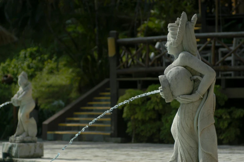 a statue of a woman drinking water from a fountain, inspired by Ma Quan, unsplash, sumatraism, still frame from a movie, weta studios, delightful surroundings, animation