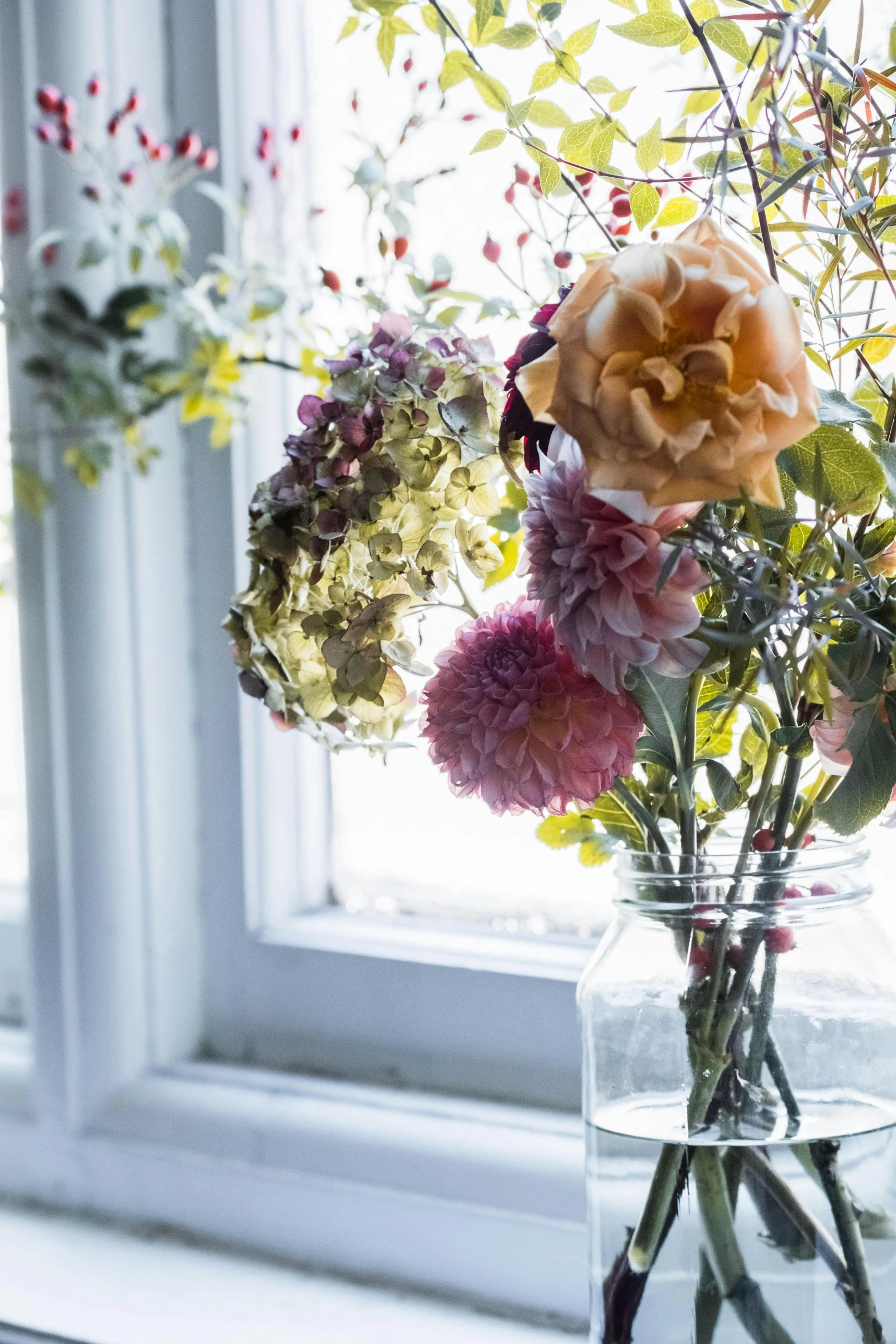 a vase filled with flowers sitting on a window sill, inspired by Henri Fantin-Latour, unsplash, soft autumn sunlight, detail shot, multi - coloured, tall