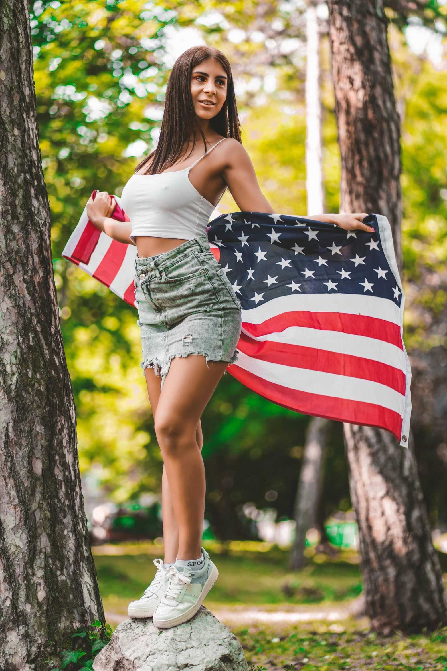 a woman holding an american flag in a park, adriana chechik, 5 0 0 px models, 🚿🗝📝
