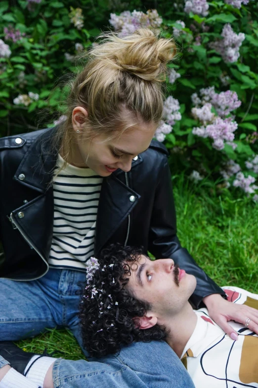 a man laying on the ground next to a woman, by Penelope Beaton, trending on unsplash, renaissance, portrait of timothee chalamet, lesbians, in garden, side portrait of imogen poots