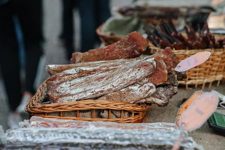 a table topped with lots of different types of meat, by Julian Hatton, pexels contest winner, renaissance, street market, animal - shaped bread, bark for skin, grey