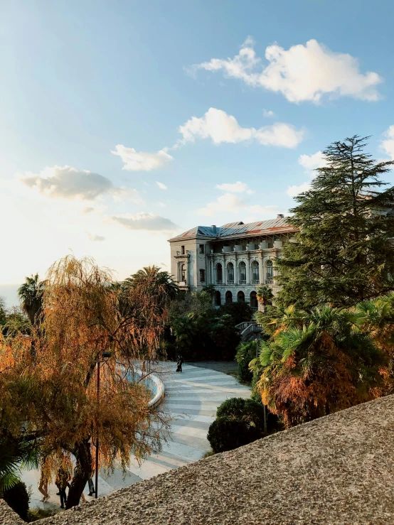 a man riding a skateboard up the side of a hill, inspired by Serafino De Tivoli, pexels contest winner, renaissance, pink marble building, an overgrown library, natural morning light, panoramic view