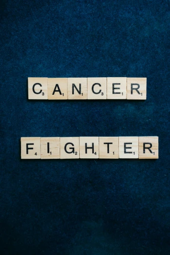 scrabbles spelling cancer and fighter on a blue background, an album cover, by Julia Pishtar, pexels contest winner, 5th gen fighter, (1 as december, medical, fights