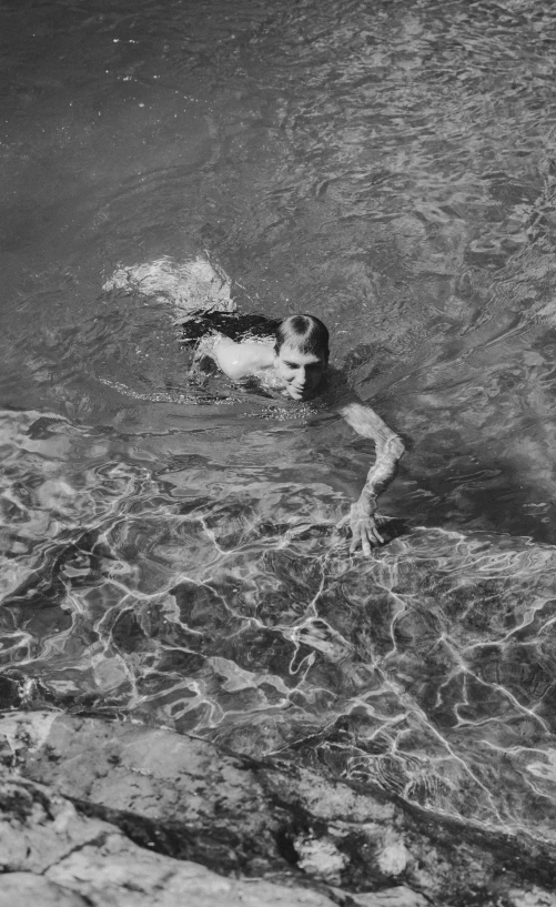 a black and white photo of a person swimming, an album cover, inspired by Max Dupain, george h.w. bush, ignant, pollock photorealistic, 1950s photograph