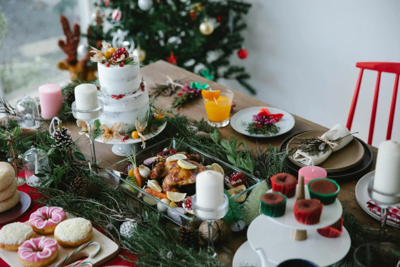 a table topped with lots of food next to a christmas tree, pexels contest winner, white table, manuka, profile image, cakes