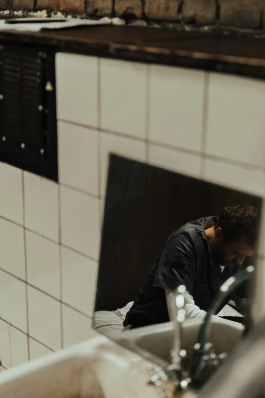 a man standing in a bathroom next to a sink, a picture, by Jacob Toorenvliet, unsplash, happening, diner scene, gif, ignant, laying down