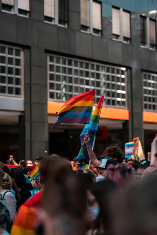 a group of people that are standing in the street, trending on pexels, lgbt flag, thumbnail, parade floats, low quality photo