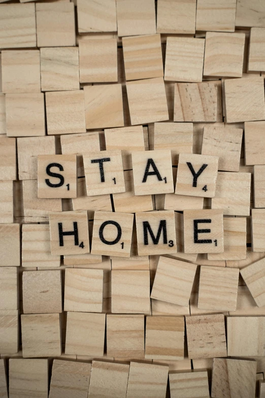 a pile of wooden blocks with the words stay home written on them, by Andries Stock, shutterstock, square, demur, wall mural, breeding