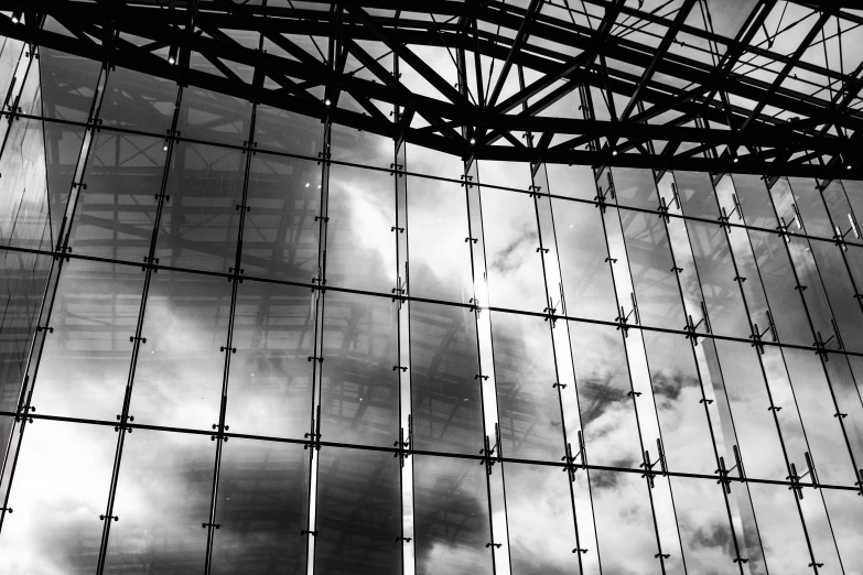 a black and white photo of the inside of a building, inspired by Richard Wilson, flickr, intricate sky, clear glass wall, magical stormy reflections, modern high sharpness photo