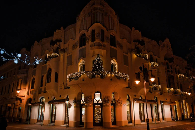 a building that is lit up at night, by Julia Pishtar, pexels contest winner, art nouveau, moorish architecture, christmas night, 2 0 0 0's photo, thumbnail