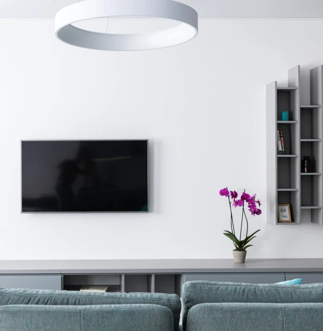 a living room filled with furniture and a flat screen tv, trending on cg society, minimalism, fluorescent ceiling lights, halo above head, grey color scheme, halo array