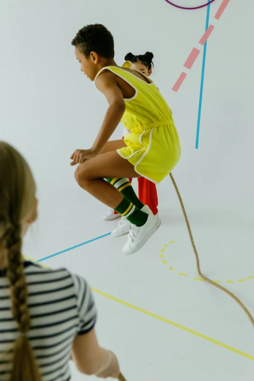 a little girl that is jumping in the air, by Nina Hamnett, interactive art, tennis wear, ropes, primary colours, off - white collection