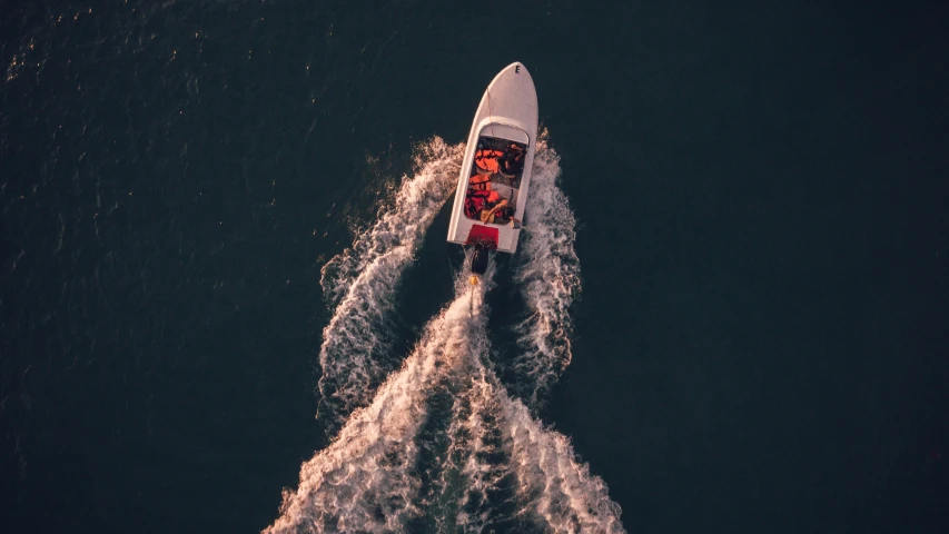 a boat in the middle of a body of water, pexels contest winner, dramatic lighting from above, excitement, vintage color, thumbnail